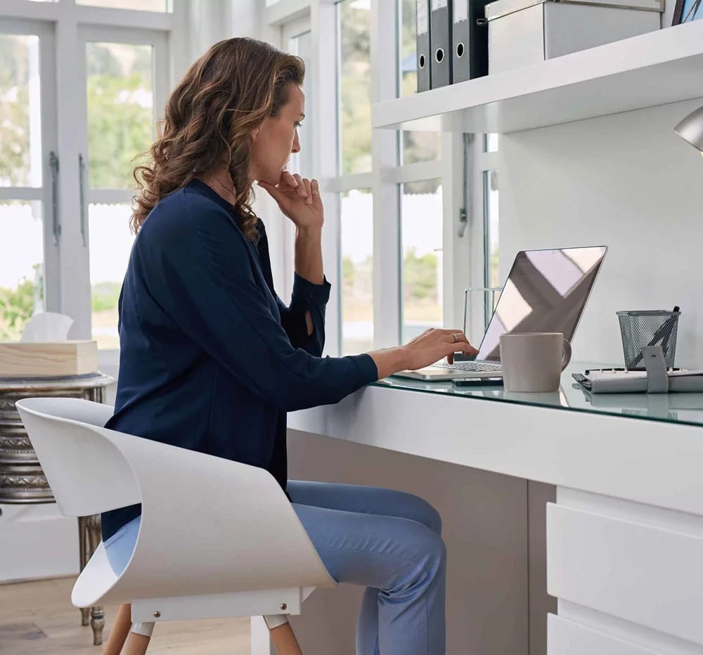 Woman on a desk with a laptop