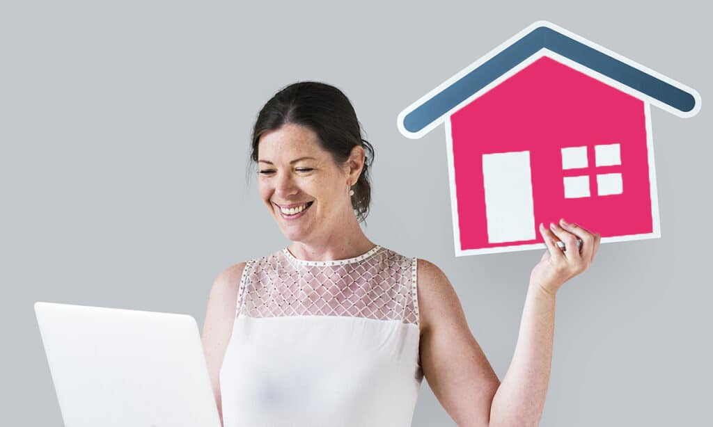 Boost Your Sales with These Must-Have Property Marketing Tools 3 Woman holding a house icon and using a laptop