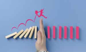 man jumping over a hand